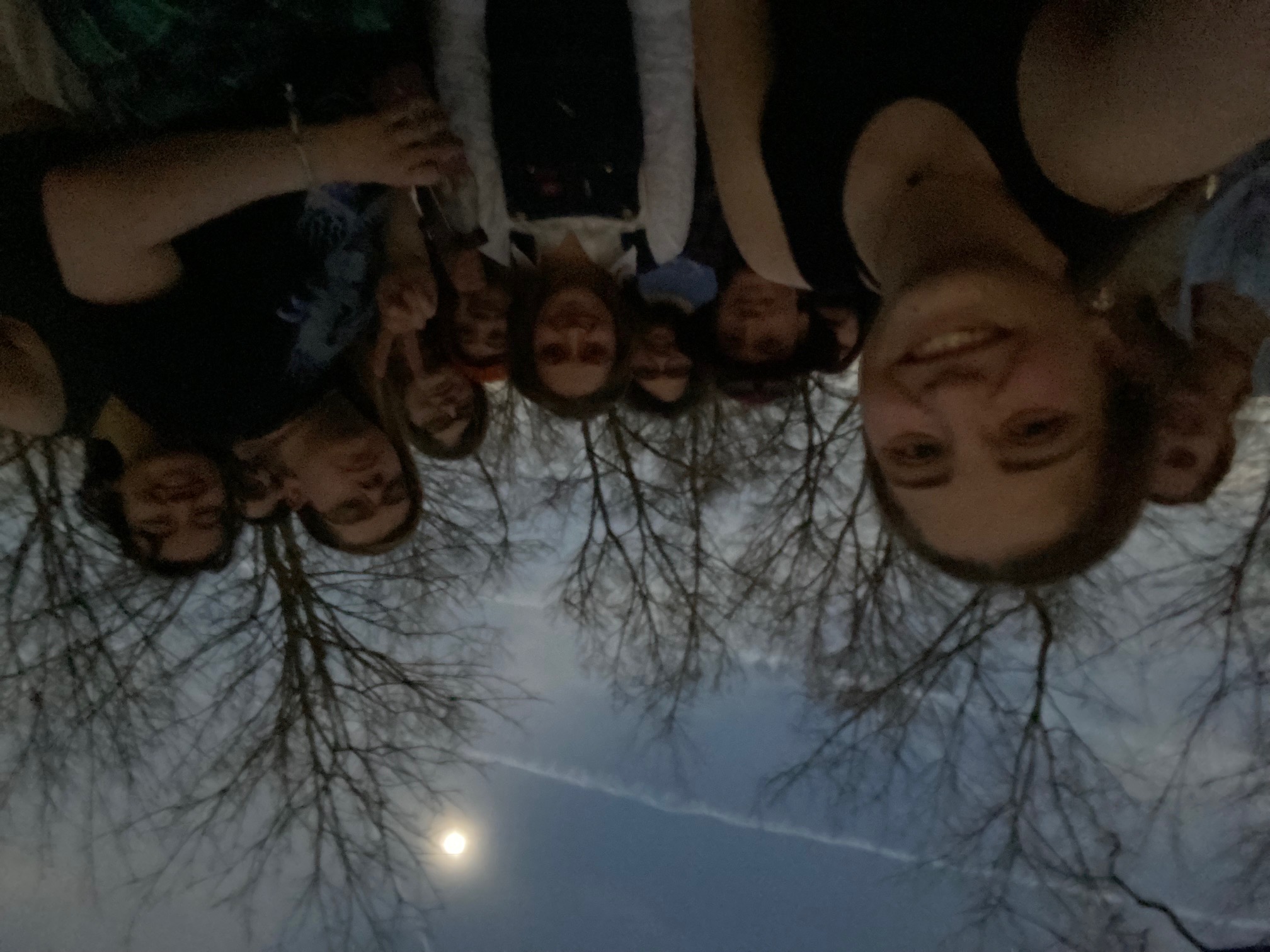 A selfie of a group of Obies with the eclipse in the background